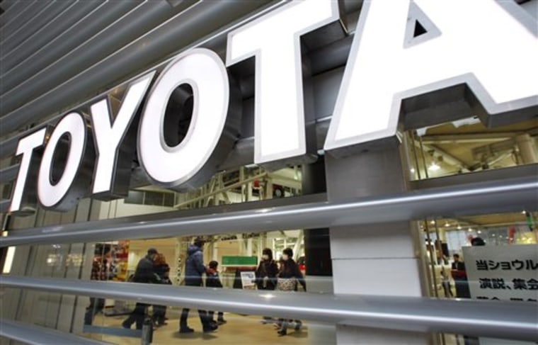 Visitors walk in a Toyota showroom. Toyota is recalling nearly 1.7 million vehicles worldwide for various defects that may cause fuel leakage and other problems, the latest in quality control woes for the Japanese automaker. 